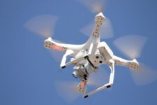 A camera drone in flight, representing UK drone flying regulations