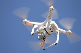 A camera drone in flight, representing UK drone flying regulations