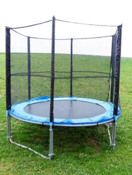 Rectangular garden trampoline with safety enclosure in a UK back garden