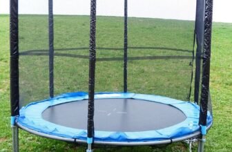 Rectangular garden trampoline with safety enclosure in a UK back garden