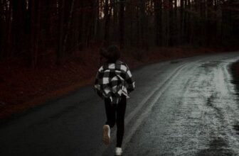 Runner on a wet forest road in activewear