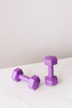Purple dumbbells on a marble surface