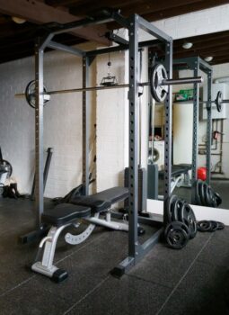 Home gym setup with weight bench, barbell and mirror