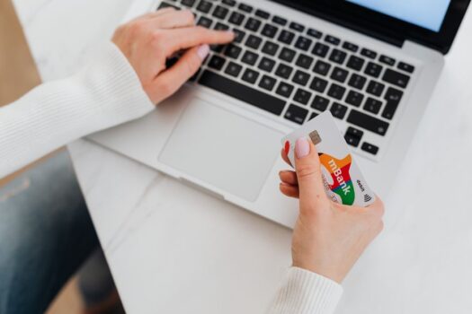 Person using a laptop and credit card to check out online